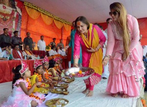 Bollywood actress Jaya Prada (left) offers Kumari Puja on the first day of the nine-day Navratri festival at Mirzapur in Uttar Pradesh