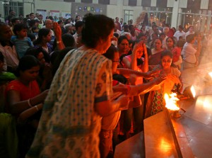 Devotees take blessings on completion of aarti at a Durga Puja pandal in Gurgaon