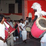 Dhakis playing dhak at a Durga Puja venue