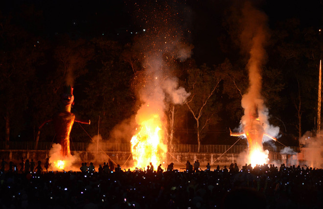 Effigies of Hindu demon king Ravan, Kumbhkaran and Meghdooth goes up in flames during Dussehra celebrations in Mandi on October 22, 2015