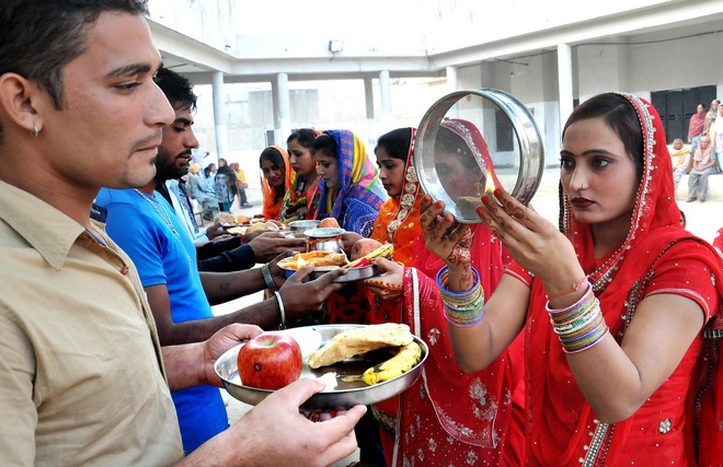 Female inmates see their husbands’ faces through sieves on Karwa Chauth, a traditional Hindu festival celebrated in northern India during which married women fast one whole day and offer prayers to the moon for the welfare, prosperity, and longevity of their husbands, at Modern Jail, Kapurthala, on October 30, 2015