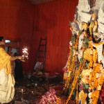 Head priest performing prayers during Durga Puja celebration in Gurgaon