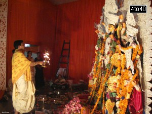Head priest performing prayers during Durga Puja celebration in Gurgaon
