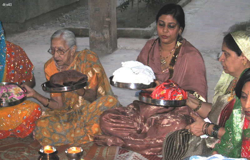 Hindu married women circulating Baya Thalis on the ocassion of Karva Chauth festival
