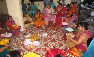Hindu married women exchange thalis during celebration of Karva Chauth festival at Cosy Apartments, Sector 9, Rohini, New Delhi
