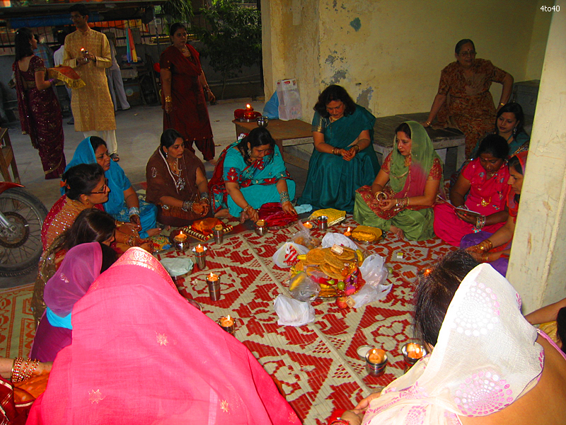 Hindu married women exchange thalis during celebration of Karva Chauth festival at Cosy Apartments, Sector 9, Rohini, New Delhi