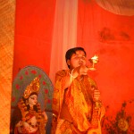 Hindu priest performing prayers at a Durga Puja pandal in Gurgaon