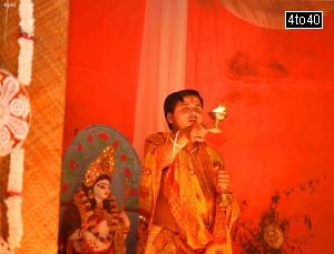 Hindu priest performing prayers at a Durga Puja pandal in Gurgaon