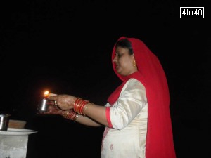 Hindu woman praying for long life of their husband and breaks the fast by looking at the moon on Karva Chauth night
