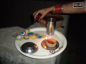 Hindu women breaks their fasting by looking at the moon and then her husbands face