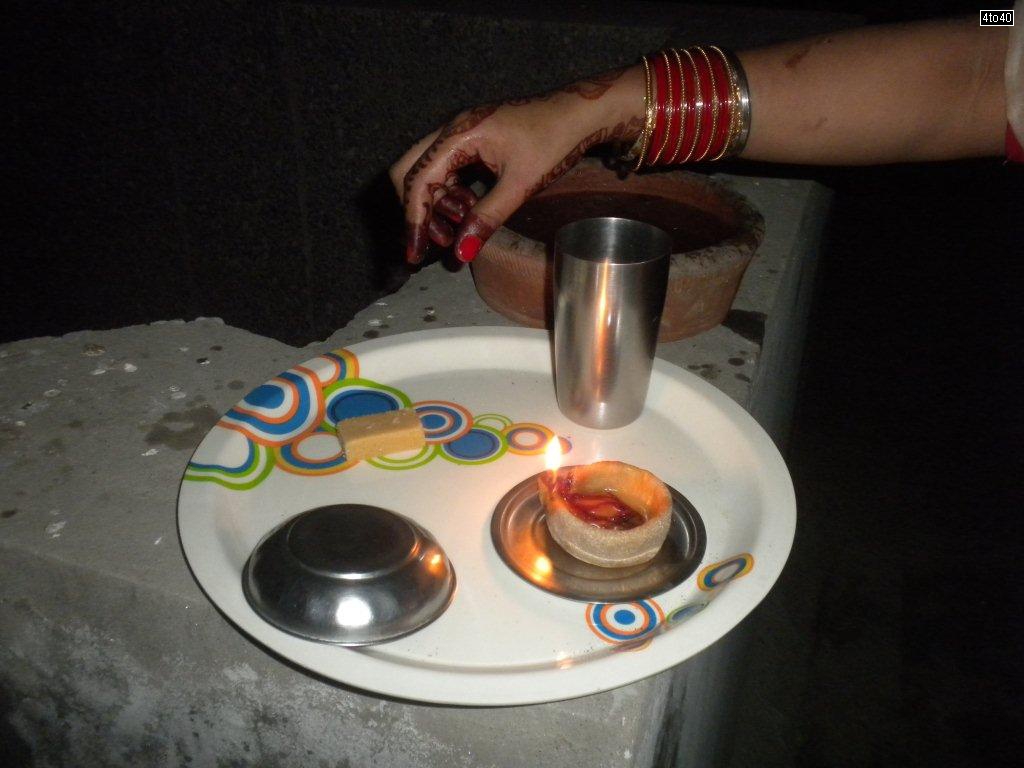 Hindu women breaks their fasting by looking at the moon and then her husbands face