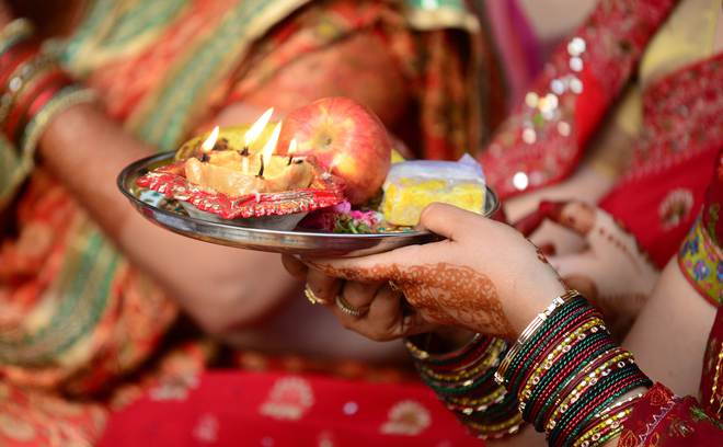 Indian married Hindu women perform rituals during Karwa Chauth, a traditional Hindu festival celebrated in northern India during which married women fast one whole day and offer prayers to the moon for the welfare, prosperity, and longevity of their husbands, in Allahabad on October 22, 2015