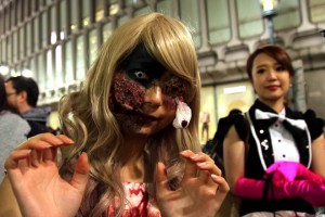 People wear costumes as they pose for pictures while taking part in a Halloween parade in Tokyo on October 31, 2015
