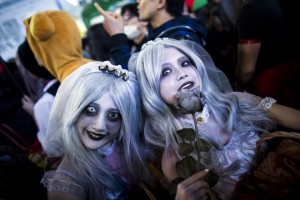 Revellers in costumes pose for pictures during Halloween celebrations in the Shibuya district in Tokyo on October 31, 2015
