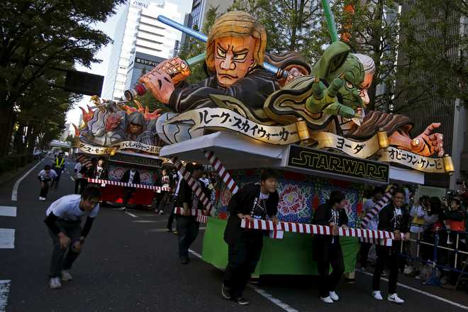 Star Wars Nebuta, an illuminated float that is traditionally shown at the Aomori Nebuta Festival in northeastern Japan, is carried by people during a Star Wars parade, which is part of a Halloween parade in Kawasaki, south of Tokyo, on October 25, 2015