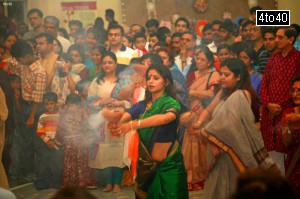 Women devotees performing Dhunuchi Naach at a Gurgaon Durga Puja Pavilion