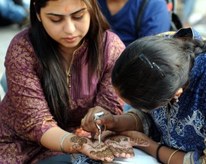 Women gets henna applied to her palms on the eve of Karwa Chauth, a traditional Hindu festival celebrated in northern India during which married women fast one whole day and offer prayers to the moon for the welfare, prosperity, and longevity of their husbands, in New Delhi on October 22, 2015