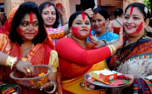Women playing with vermillion powder (Sindoor Khela) on the last day of the Durga Puja festival in Chandigarh