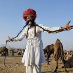 A herder poses for a photograph at the Pushkar camel fair Rajasthan