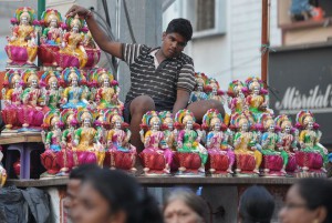 A vendor sells statues of Hindu Goddess Lakshmi at a roadside stall on the eve of Diwali in Hyderabad