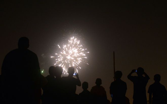 Athletes watch fireworks at the Madan Mohan Malviya stadium on the eve of the Hindu festival of Diwali in Allahabad