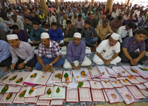Businessmen sit beside their record-keeping books as part of a ritual to worship the Hindu deity of wealth goddess Lakshmi on Diwali, the festival of lights, in Ahmedabad on November 11, 2015