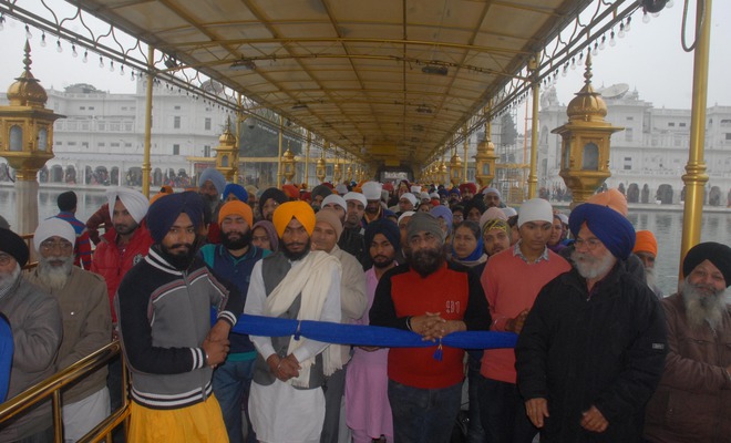Devotees offer prayers at the Golden Temple on the birth anniversary Guru Gobind Singh in Amritsar on January 16, 2016