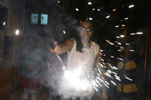 Girl holds a sparkler on the eve of Diwali in Hyderabad on November 10, 2015