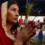 Hindu devotees offer prayers during the Chhat festival on the banks of the river Yamuna in New Delhi on November 17, 2015