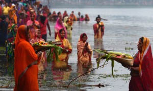 Hindu devotees offer prayers to the sun during the Chhath festival in Kolkata on November 17, 2015. Hindu devotees pay obeisance to both the rising and the setting sun in the Chhath festival when people express their thanks and seek the blessings of the forces of nature, mainly the sun and river