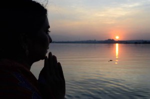 Hindu devotees offer prayers to the sun during the Chhath festival on the banks of the Hussain Sagar Lake in Hyderabad on November 17, 2015