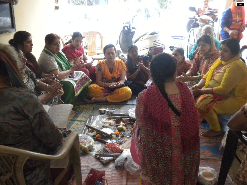 Hindu women performing Govardhan Puja at Cosy Apartments, Sector 9, Rohini, New Delhi