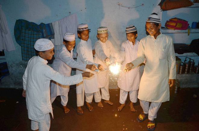 Muslim children celebrating Diwali with sparklers at a Madarsa in Mirzapur, Uttar Pradesh