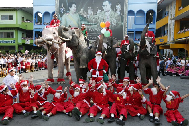 Children dressed as Santa Claus and elephants pose for a picture during a Christmas festival in a primary school in Ayutthaya, Thailand, on December 24, 2015