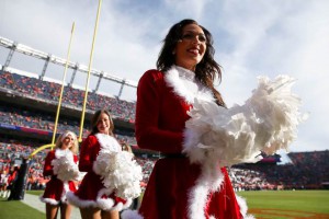 Denver Broncos cheerleaders dressed in Santa Claus-themed outfits stand on the sideline before a game between the Denver Broncos and the Oakland Raiders at Sports Authority Field at Mile High on December 13, 2015 in Denver, Colorado