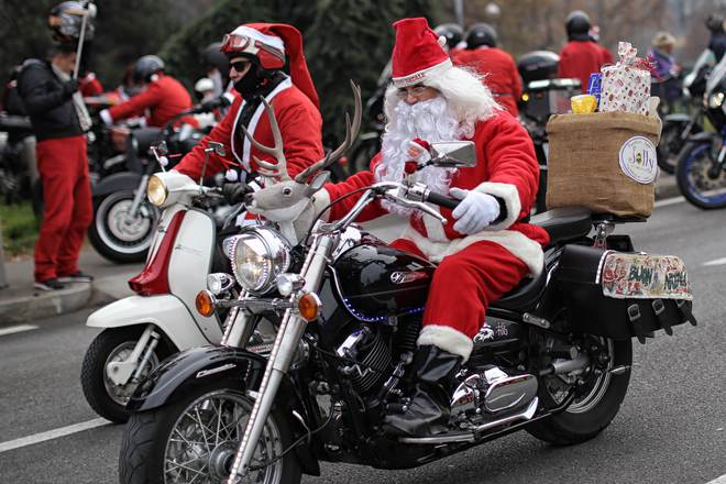 Participants ride bikes as they take part in the 6th edition of the Santa Claus 'Papa Noel' rally on December 13, 2015 in Turin