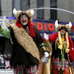 People dressed in costumes make their way down 6th avenue during the 89th Macy's Thanksgiving Day Parade in the Manhattan borough of New York on November 26, 2015.