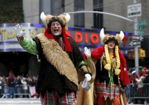 People dressed in costumes make their way down 6th avenue during the 89th Macy's Thanksgiving Day Parade in the Manhattan borough of New York on November 26, 2015.