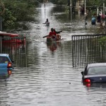 People ferried across a flooded road to safer places in Chennai on December 2, 2015.
