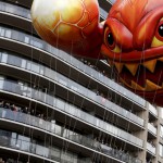 The ‘Skylanders Eruptor’ balloon moves by people on balconies during the 89th Macy's Thanksgiving Day Parade in the Manhattan borough of New York on November 26, 2015.