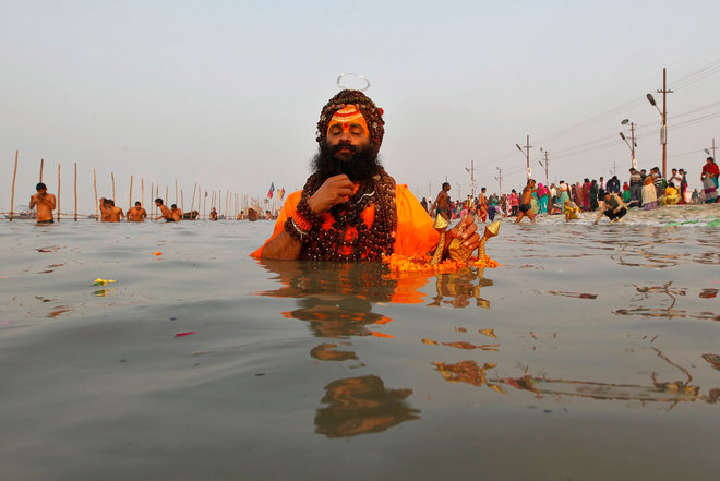 A Sadhu prays as he takes a dip at Sangam, a confluence of three rivers, the Ganga, the Yamuna and the mythical Saraswati, on the occasion of Makar Sankranti festival in Allahabad, on January 14, 2017