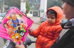 A man buys a kite with cartoons printed on it for his child on the eve of Lohri in Ludhiana