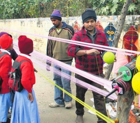 A man prepares colorful kite strings ahead of Lohri festival in Jalandhar