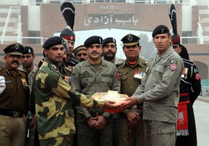 BSF DIG Sumer Singh offering sweets to Wing Commander Pak Rangers, Bilal Ahmed at the Attari Wagah joint check post to mark the 67th Republic