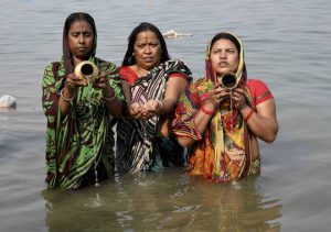 Devotees offering prayers as they take the holy dip in the river Ganga on the occasion of Makar Sankranti, in Patna