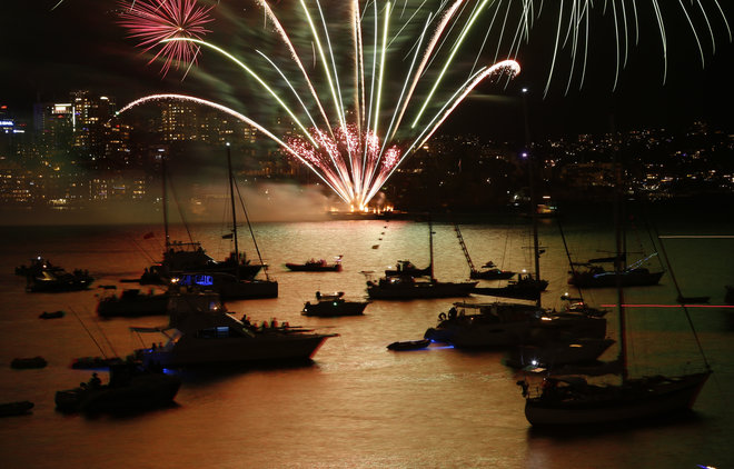 Fireworks explode over boats anchored on Sydney Harbour during a 9pm display before midnight fireworks usher in the new year in Australia's largest city, December 31, 2015