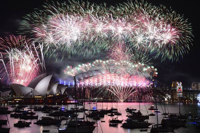 Fireworks light up the sky over Sydney's Opera House (L) and Harbour Bridge during New Year celebrations in Sydney on January 1, 2016