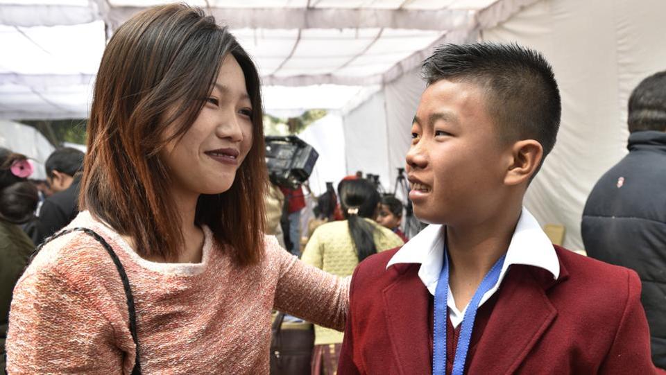 Fourteen-year-old Moirangthem Sadananda Singh at the function with his sister. He won an award for saving his mother from electrocution at home