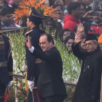 French President Francois Hollande and Indian President Pranab Mukherjee wave to spectators as they arrive for the Republic Day Parade in New Delhi
