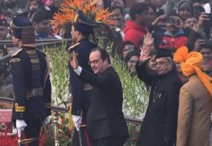 French President Francois Hollande and Indian President Pranab Mukherjee wave to spectators as they arrive for the Republic Day Parade in New Delhi